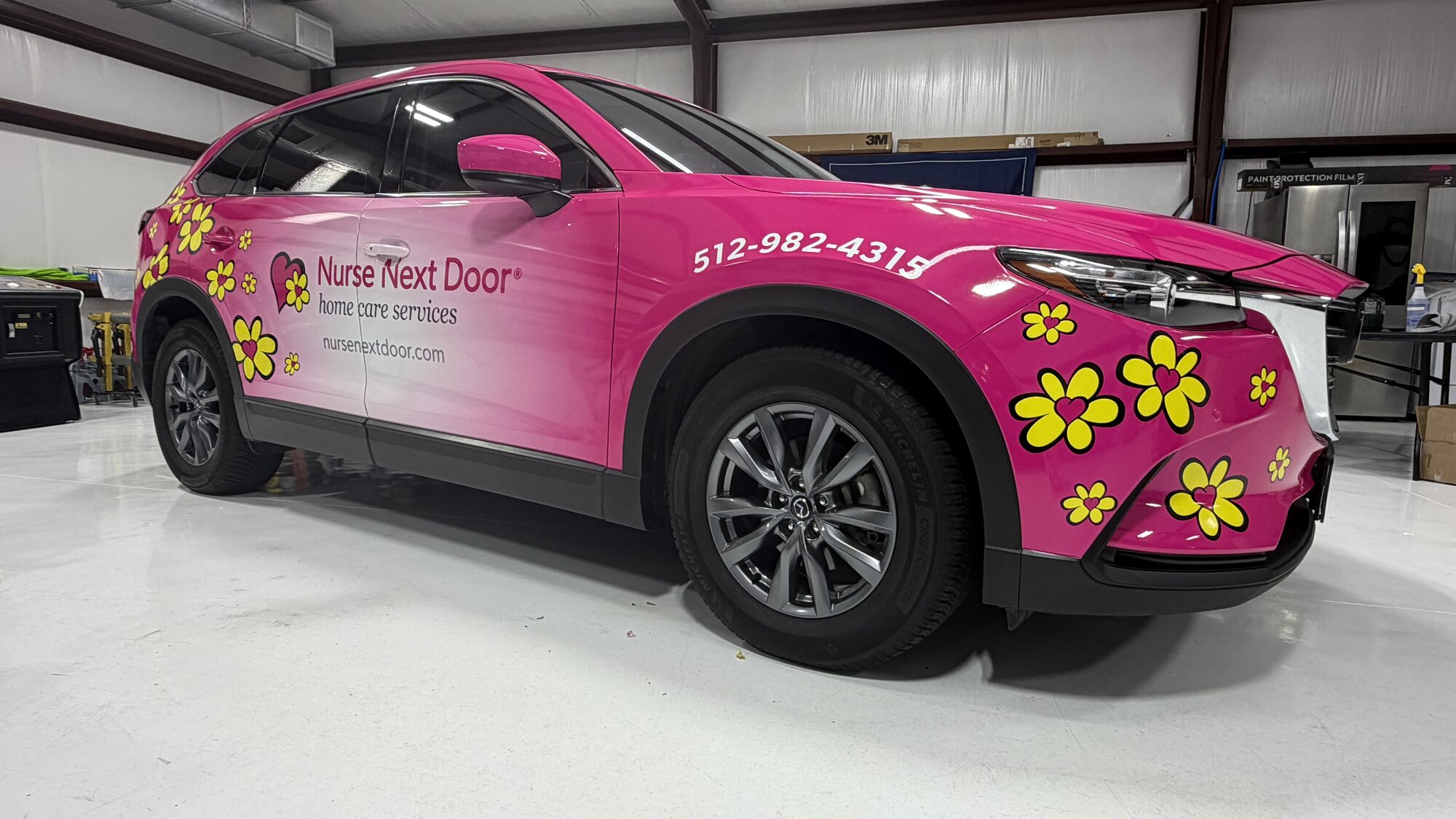 Pink Nurse Next Door Mazda CX-9 with commercial wrap