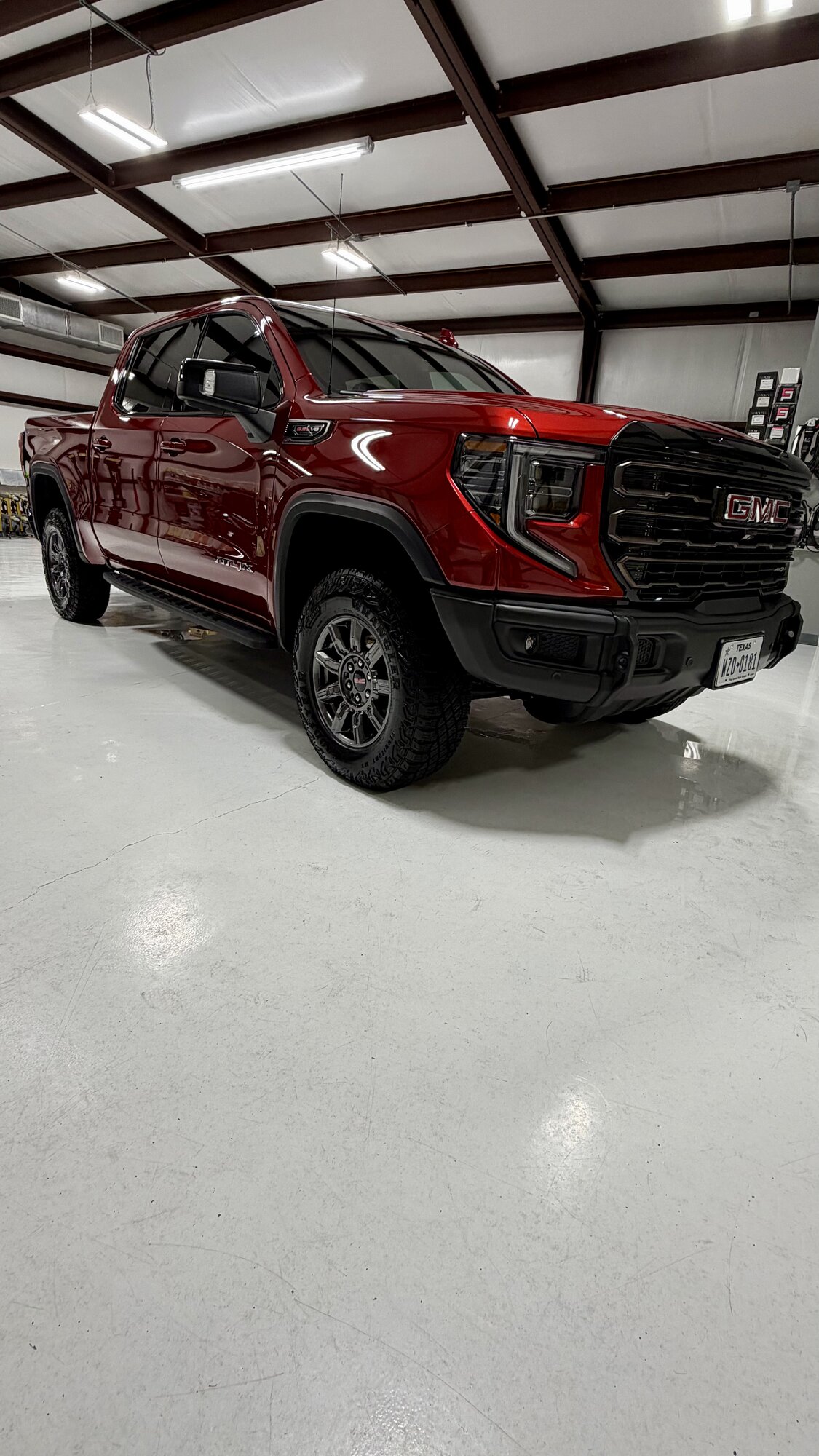 Red GMC Sierra AT4X after paint correction in the studio