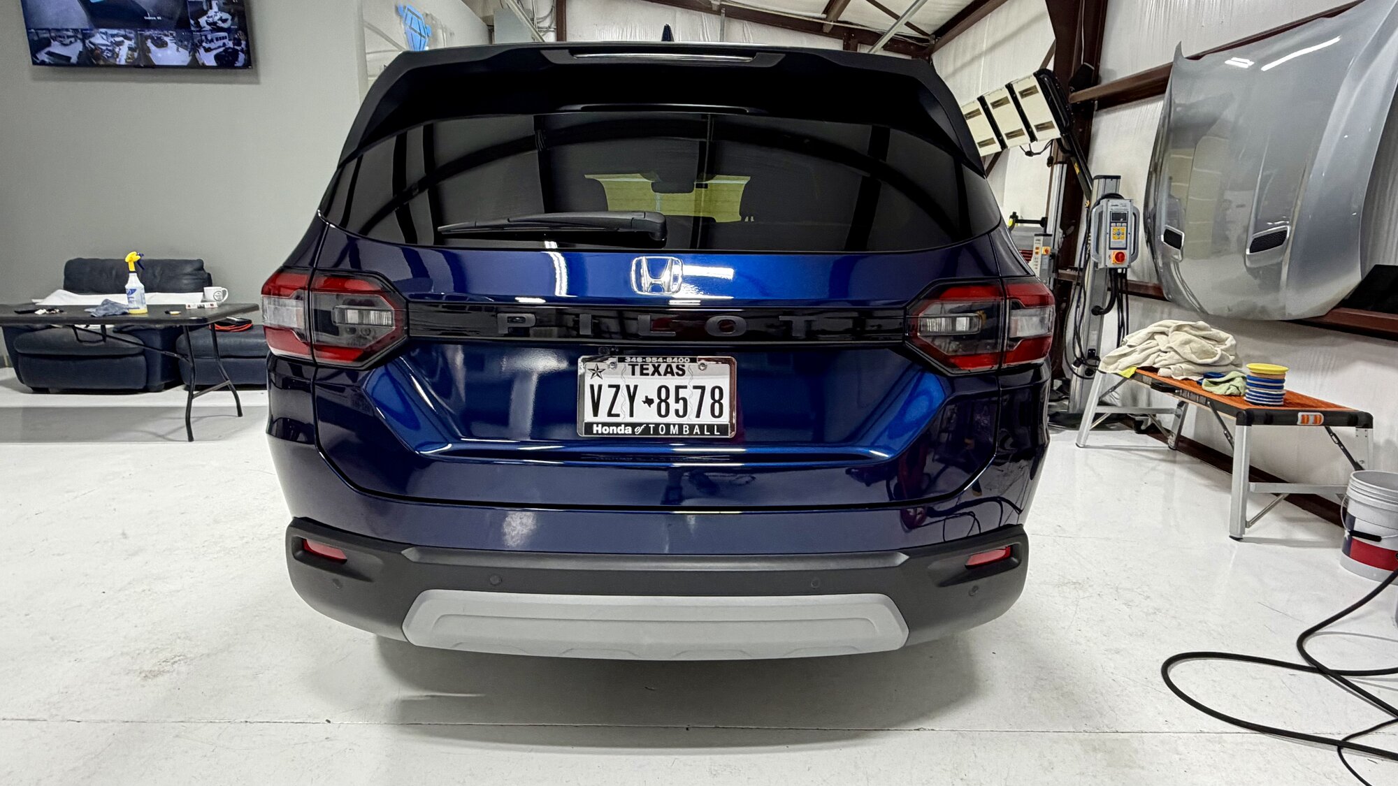 Blue Honda Pilot after paint correction in the studio