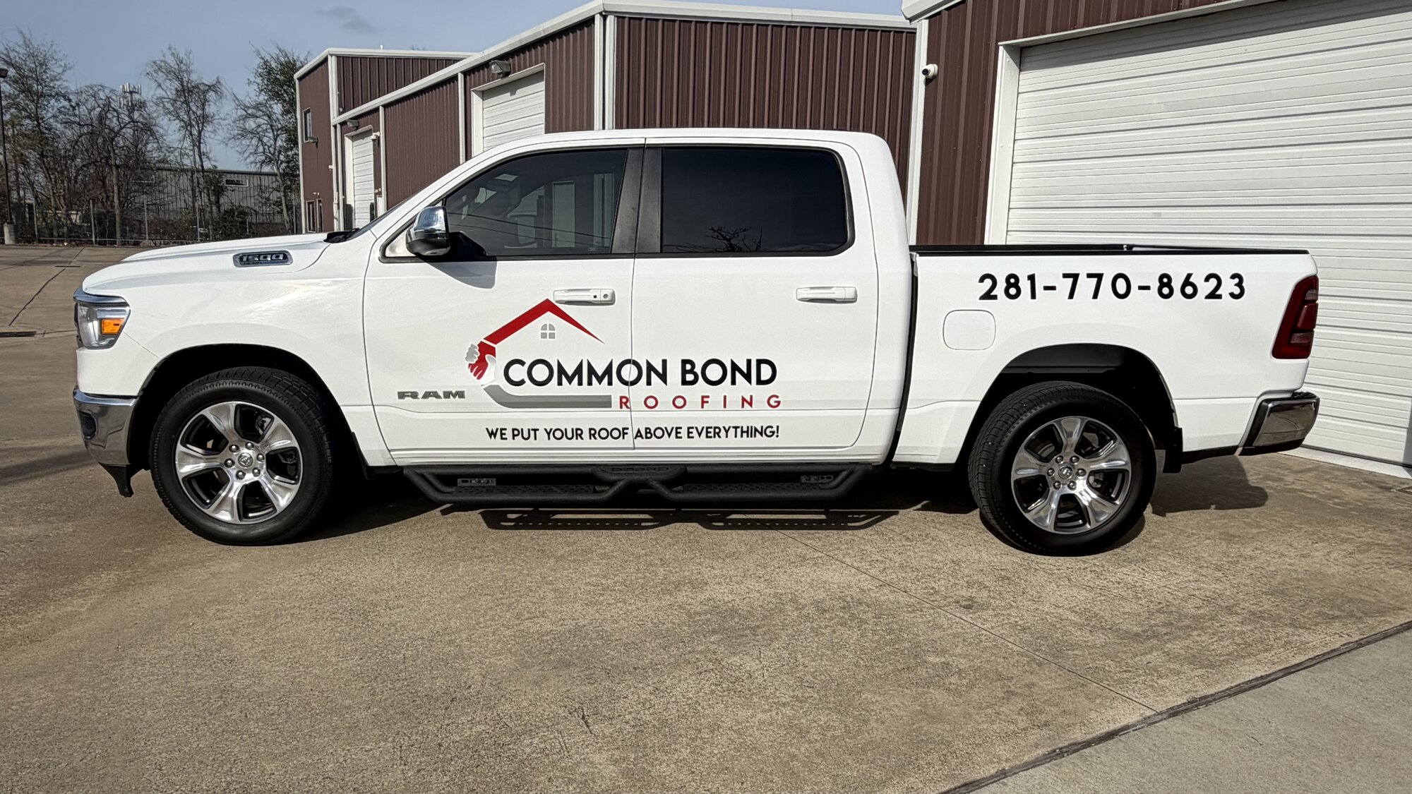 White Common Bond Roofing Ram 1500 with commercial graphics