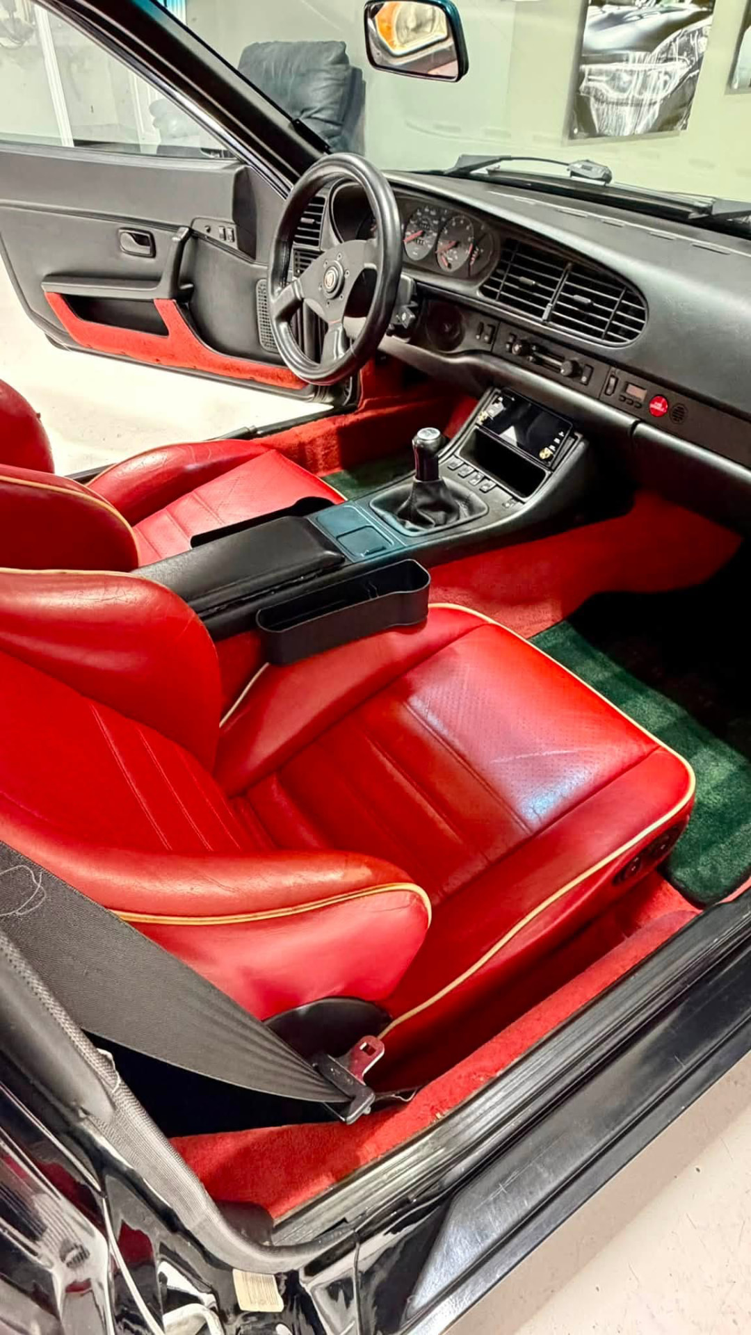 Red leather interior of a black 1986 Porsche 944 after an interior detail